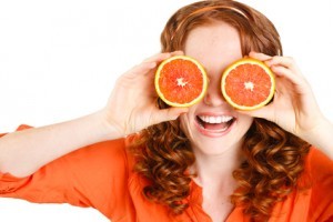 Portrait of a beautiful young woman with red hair oranges